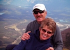 A couple hugging on a hill; scenic background