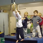 Group of children with three coaches in a gym