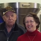 Man and woman in front of machinery