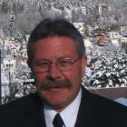 A man standing in front of houses; winter.