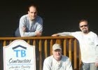 Three men at the front of a house
