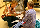 two women veterinarians feeding a fawn