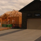 A house under construction beside a newly constructed home.