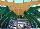 The interior view of the construction site, with huge arching beams coming together in the centre at the top