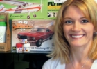 woman standing beside a shelf full of hobby items