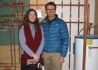 Photo of people standing next to a hot water tank.