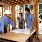 People standing in a house under construction