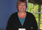 Marion Mazzocchi holding a rack of remedies