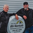 husband and wife beside an RV unit