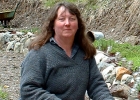 Jacki Cammidge kneeling beside a garden