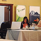 people gathered at tables listening to a keynote speaker at the itech show 2011