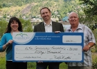Photo of three people holding a novelty cheque