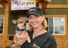 Karla Shalley and puppy in front of her pet boarding and grooming business.