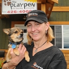 Karla Shalley and puppy in front of her pet boarding and grooming business.