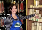 Emmie standing next to a rack of candles