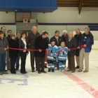 Two young hockey players cut ribbon in hockey arena