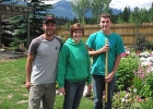 Photo of three people standing outside in a garden