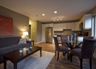The photo shows a living room, dining and kitchen area tastefully furnished and designed.