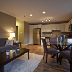 The photo shows a living room, dining and kitchen area tastefully furnished and designed.