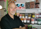 man standing beside a shelf of sweets