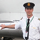 person standing beside an airplane