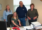 Rachel Gutwald sits at the mayor's desk in his city hall office.