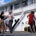 People dancing on the boat's deck