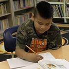 kids studying around a table