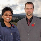 A woman and a man stand with mountains in the background