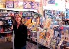 Kari Barkley stands in front of a selection of toys