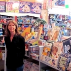 Kari Barkley stands in front of a selection of toys