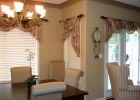 A photo of a living room with white chairs.