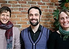 two ladies and a man standing together
