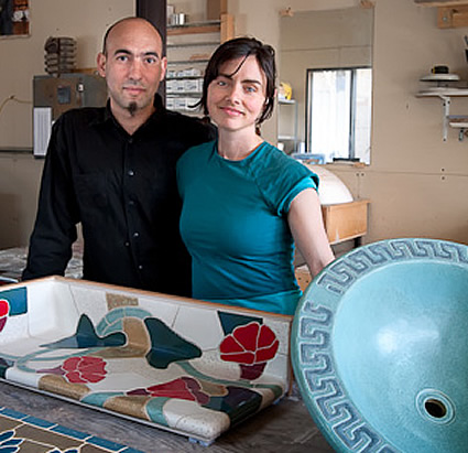 Raffo and Lynch standing beside some of their ceramic work