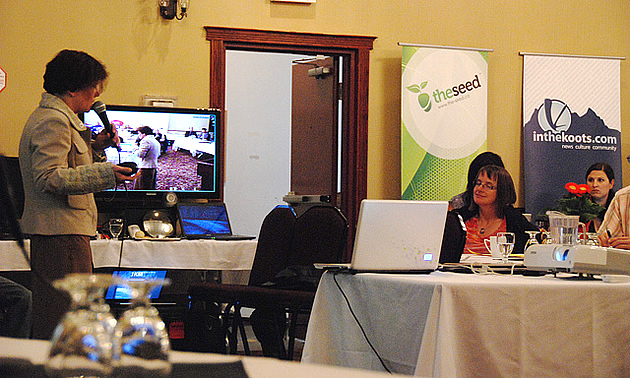 people gathered at tables listening to a keynote speaker at the itech show 2011