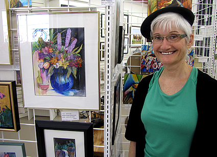 Nicole Leblond standing beside a painting