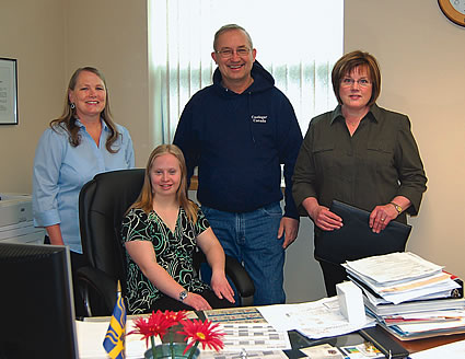Rachel Gutwald sits at the mayor's desk in his city hall office.