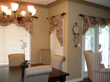 A photo of a living room with white chairs. 